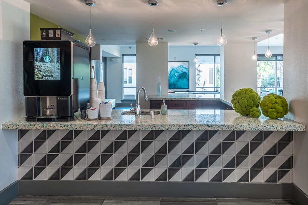 a kitchen with a granite counter top and a tv