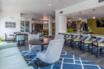 a clubhouse with tables and chairs and a bar