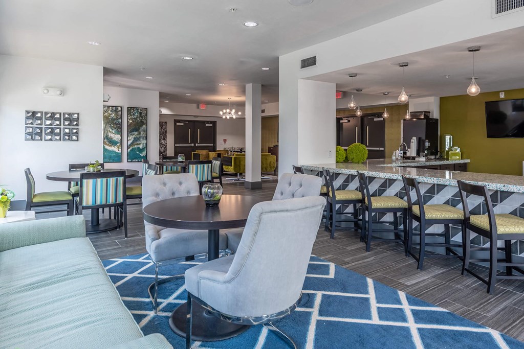 a clubhouse with tables and chairs and a bar