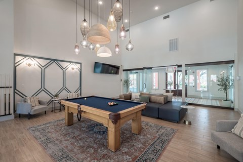a living room with a pool table in the center