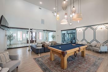 a living room with a pool table in the middle