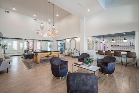 a clubhouse with a pool table and chairs
