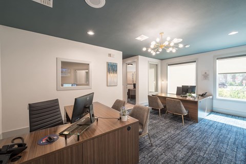 a conference room with a desk and chairs