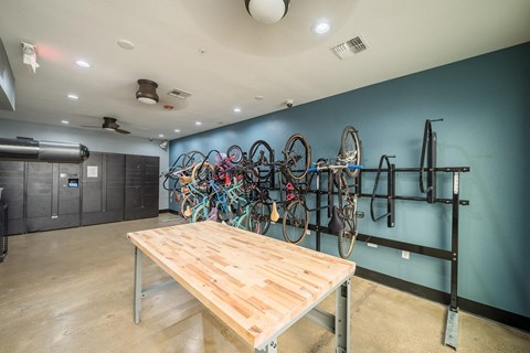 a room with a table and bikes on the wall
