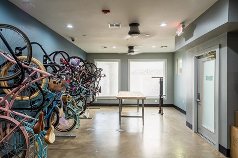 a room with a bunch of bikes on the wall