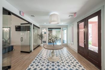 a lobby with a round table and a blue and white rug