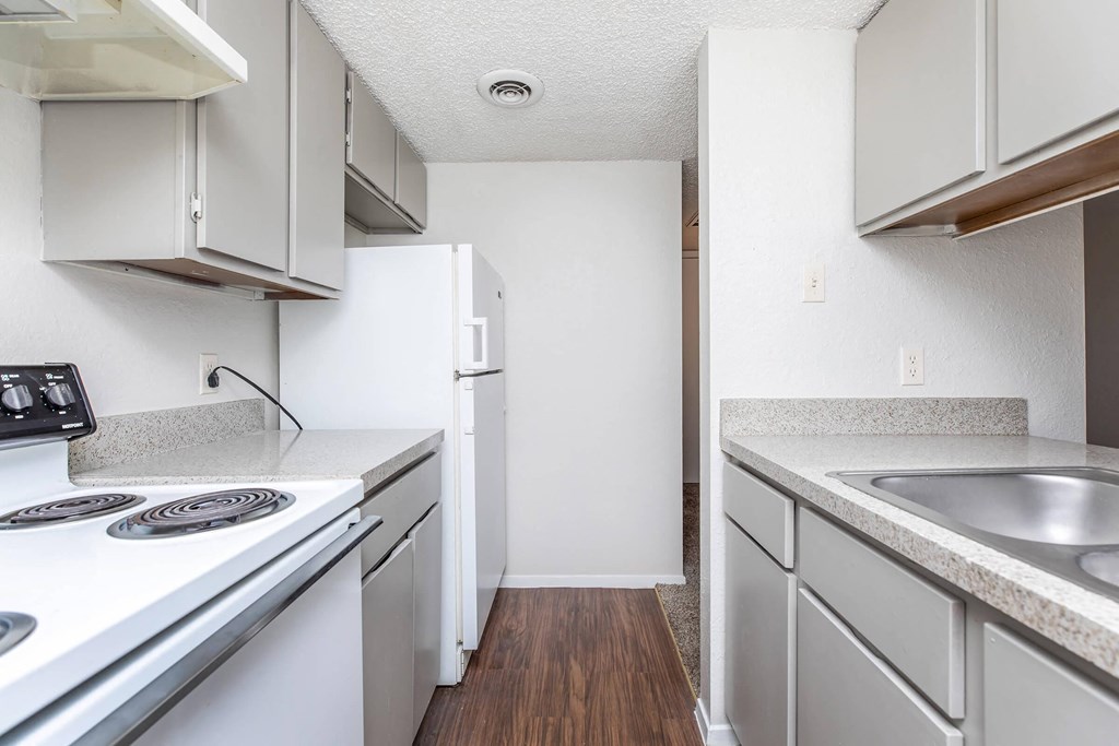 a kitchen with white appliances and white cabinets