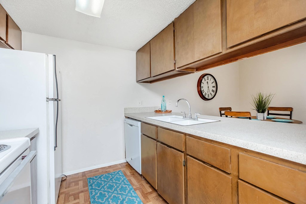 a kitchen with wooden cabinets and a white refrigerator