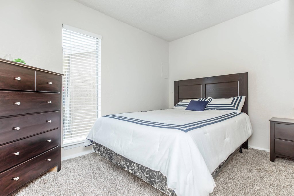 a bedroom with a bed and a dresser