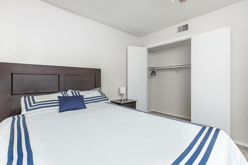 a bedroom with a large bed and a closet