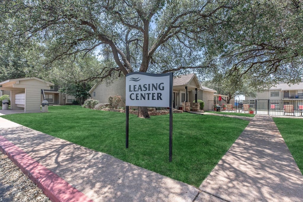 a leasing center sign in front of a house