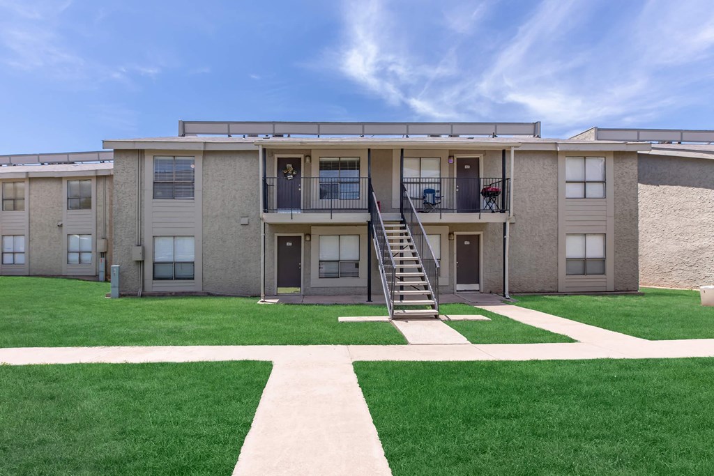 an exterior view of a building with a lawn