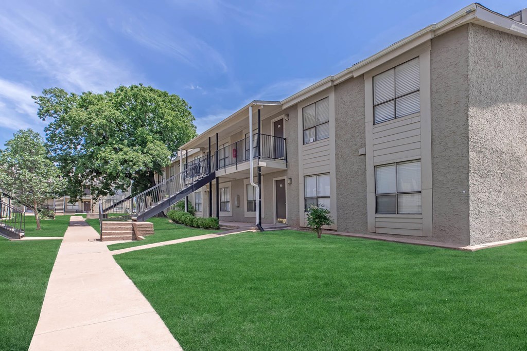 our apartments feature a spacious courtyard with green grass