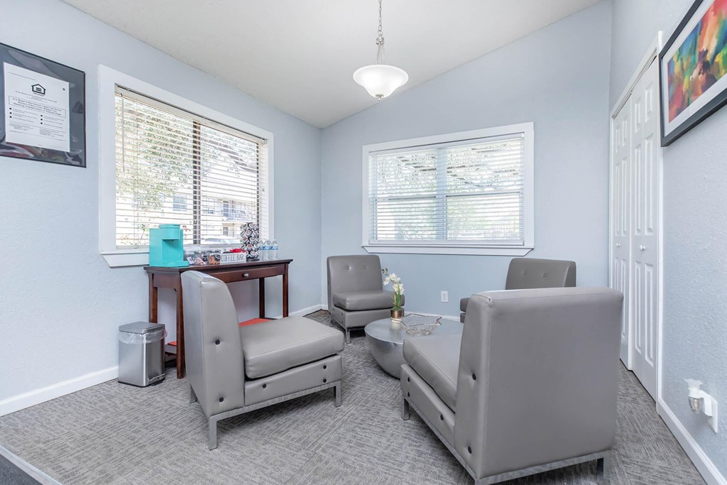 a living room with couches and chairs and a table