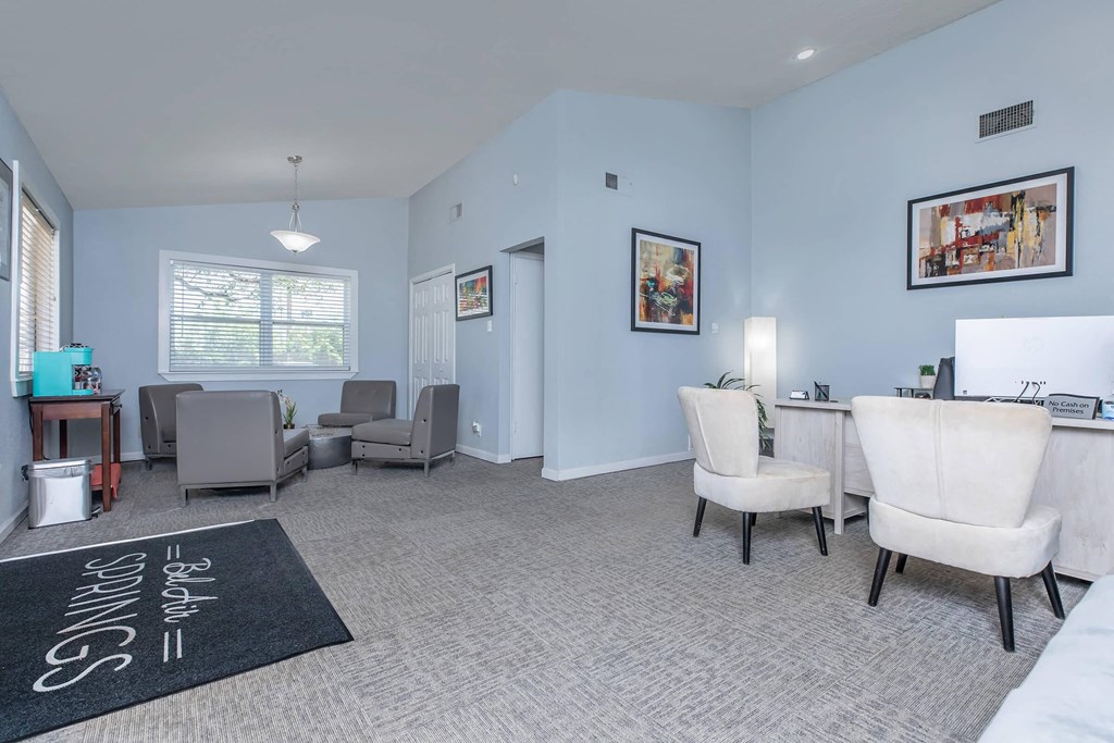 a living room with blue walls and white furniture