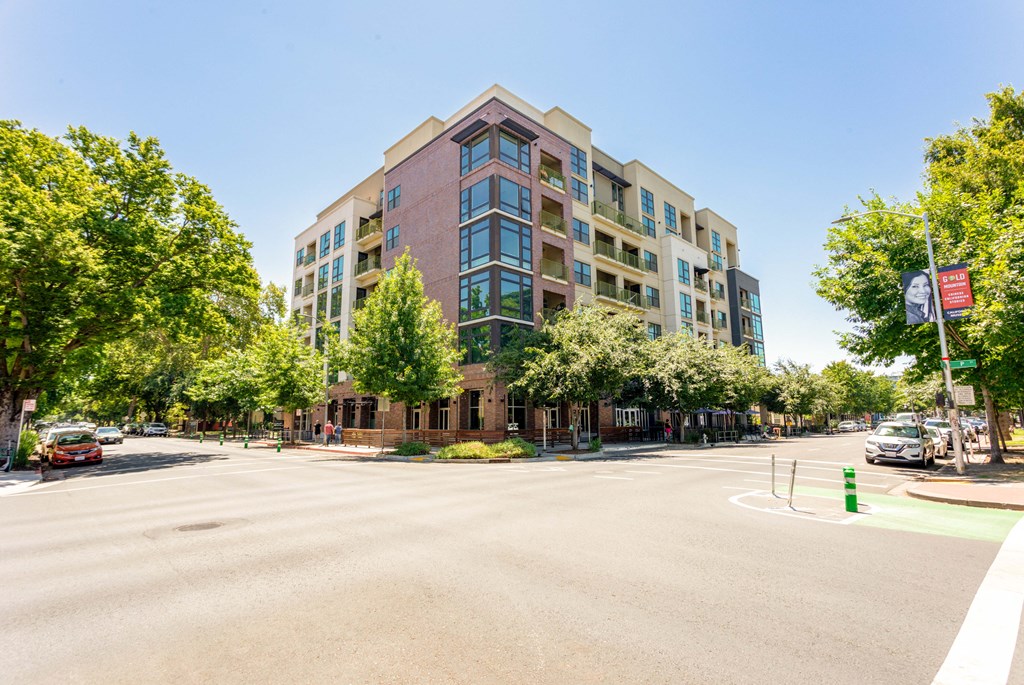 An empty street with 16 Powerhouse apartments on the corner of 16th and P street