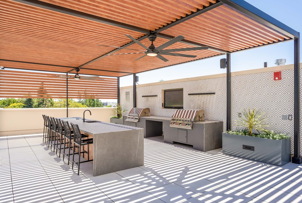 a patio with a table and chairs under a patio purgulla