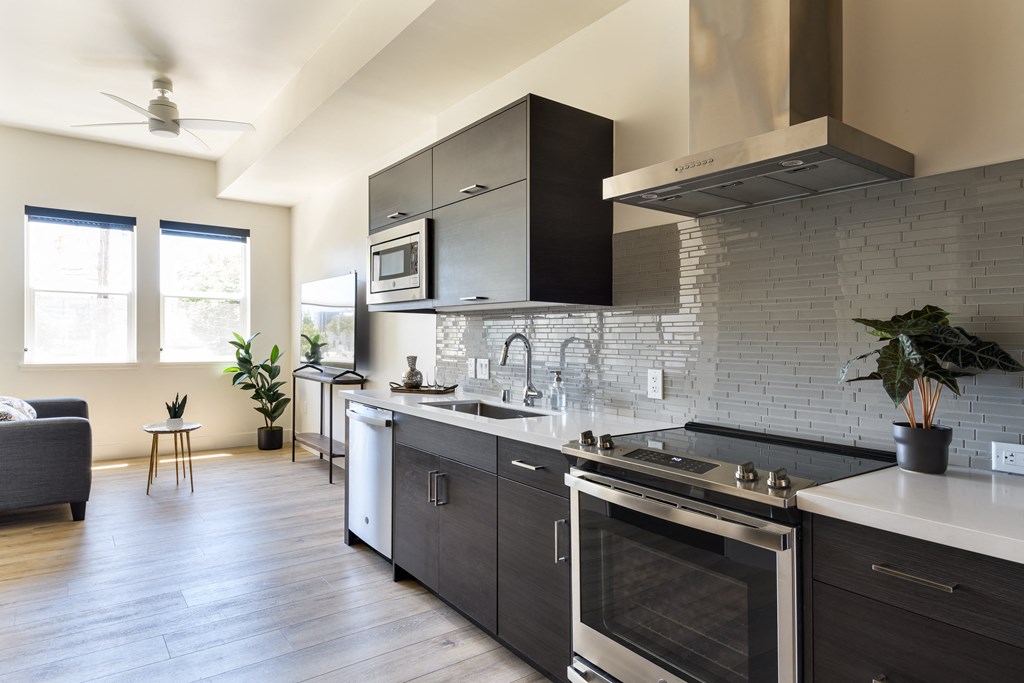 a kitchen with a stove top oven and a sink