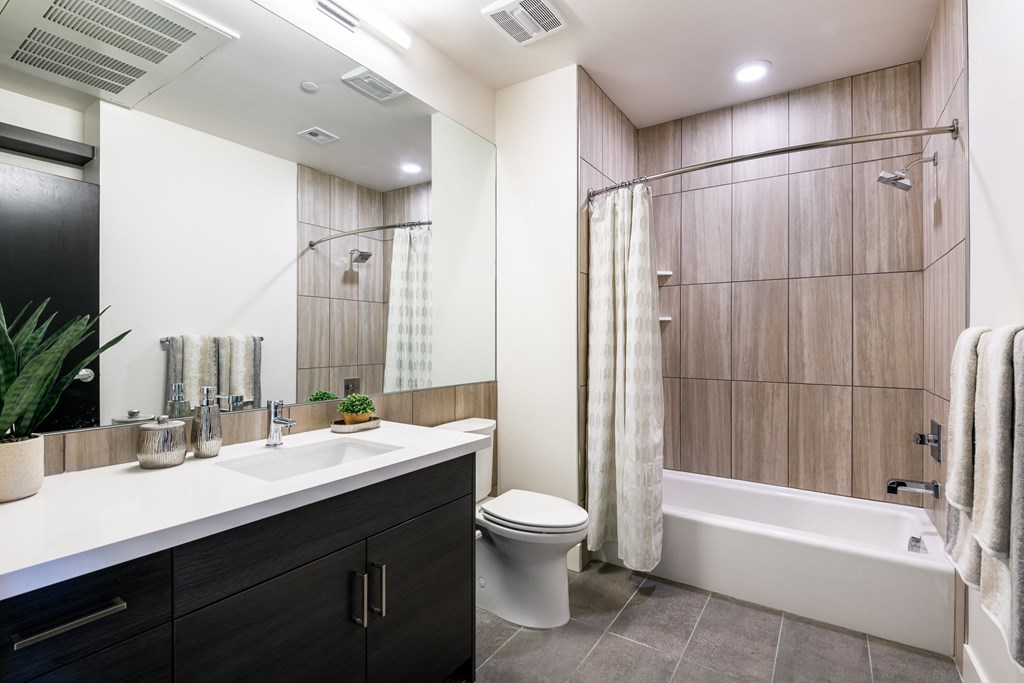 a bathroom with a toilet sink and a shower