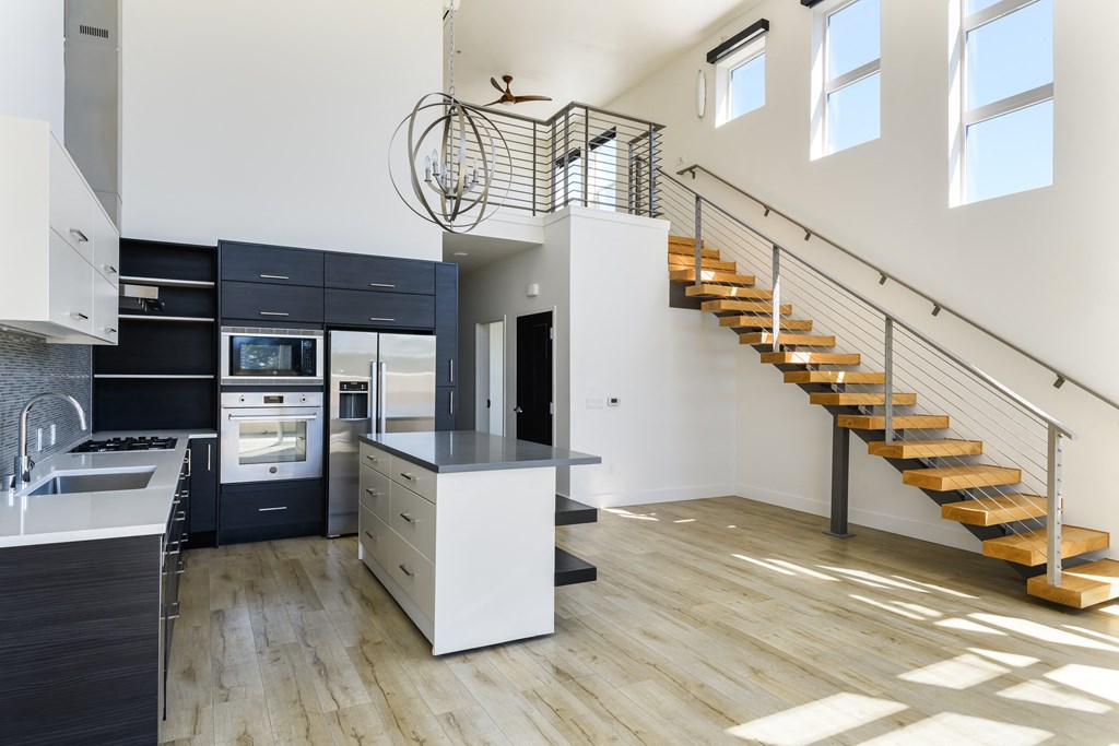 a kitchen with a staircase and a counter top in a Loft apartment