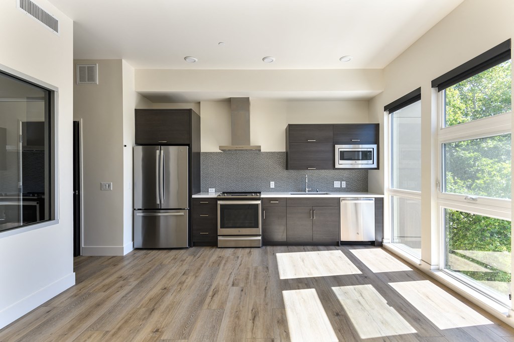 a kitchen with stainless steel appliances and a large window
