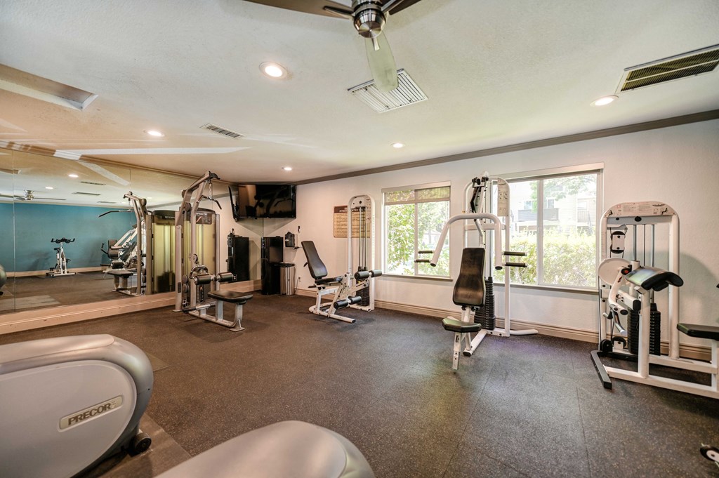 A spacious home gym with a variety of exercise equipment.