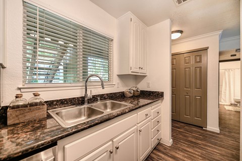 a kitchen with a sink and a window