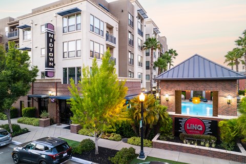 LINQ Midtown, Sacramento, CA. Exterior photo showing the monument sign and leasing office front entrance.