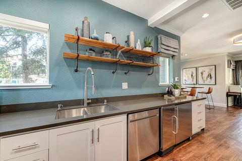 a large kitchen with stainless steel counter tops and a sink
