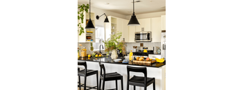 A kitchen with black countertops and white cabinets.