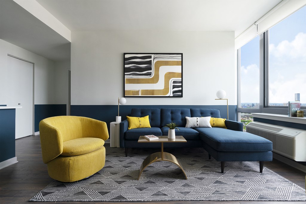 a living room with a blue couch and a yellow chair