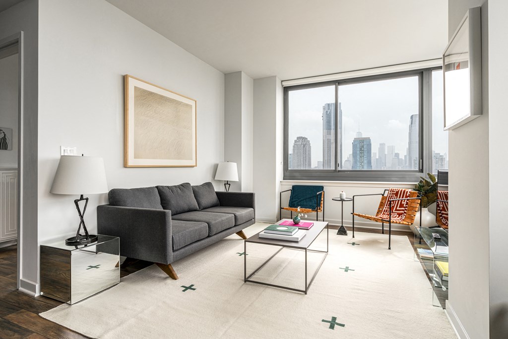 a living room with a large window and a couch and a table