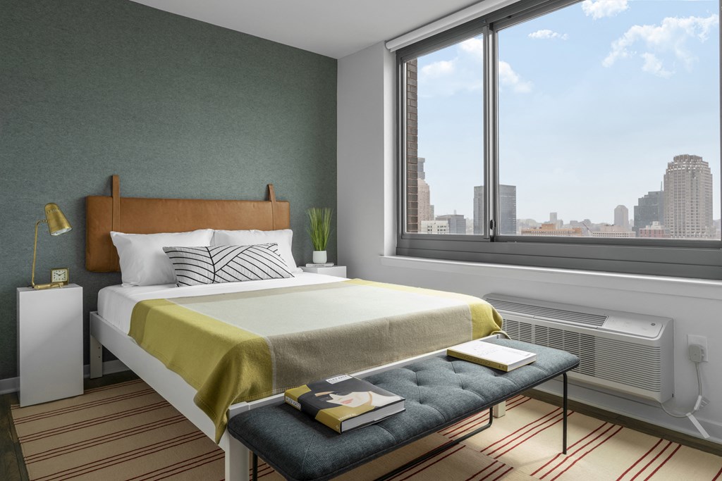 a bedroom with a bed and a window