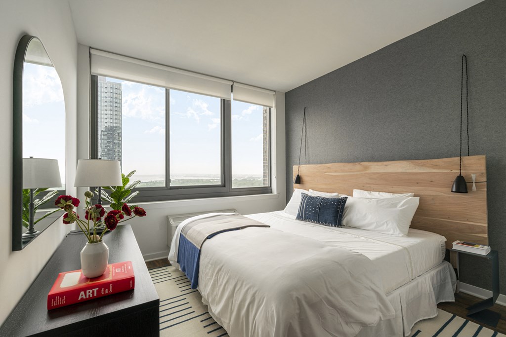 a bedroom with a large bed and a window