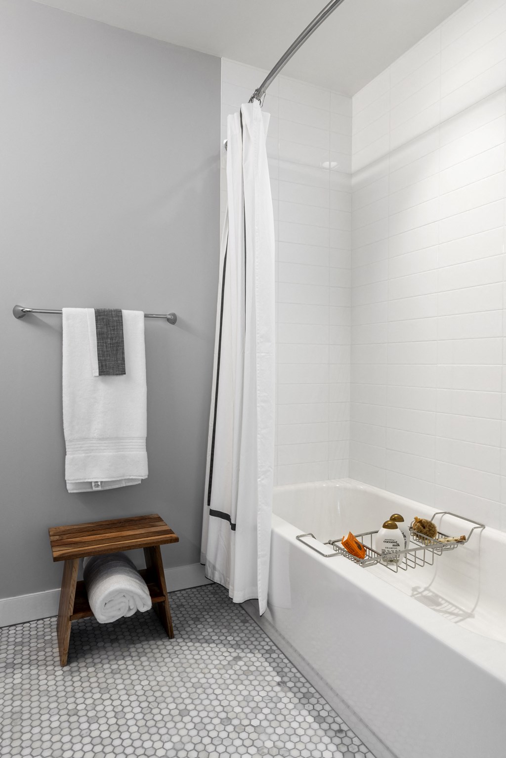 a bathroom with a shower and a bath tub and a wooden stool