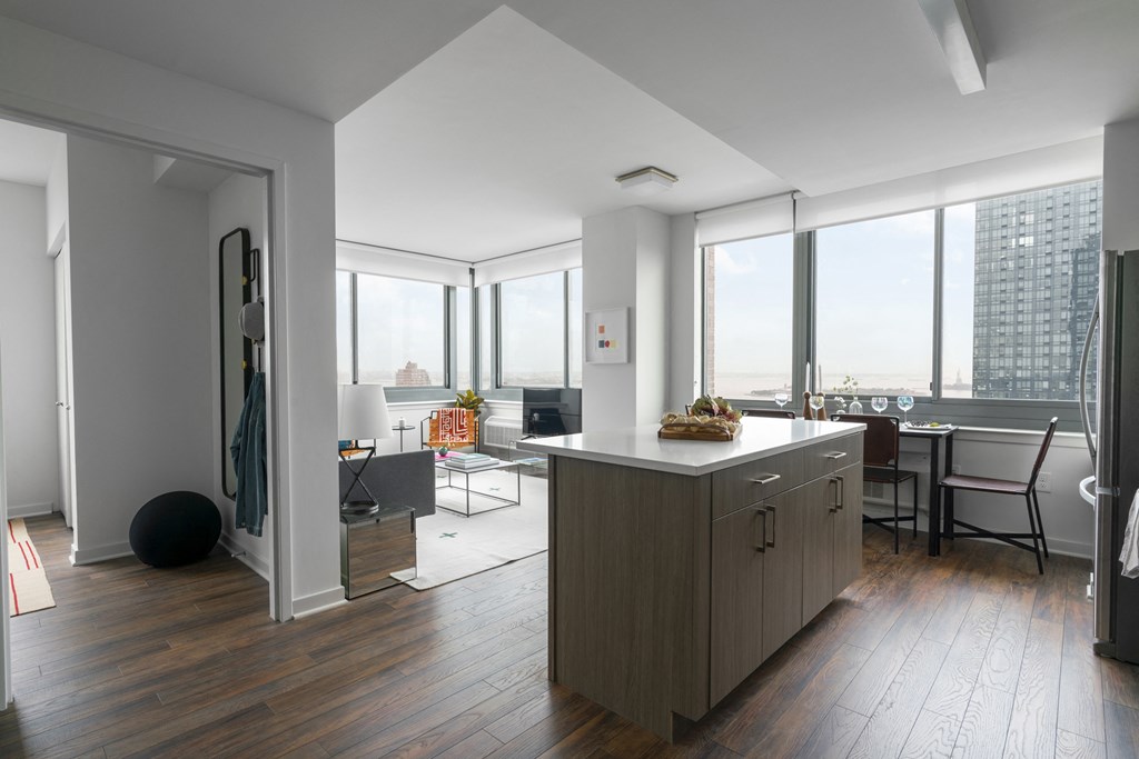 a kitchen with a island and a view of a living room