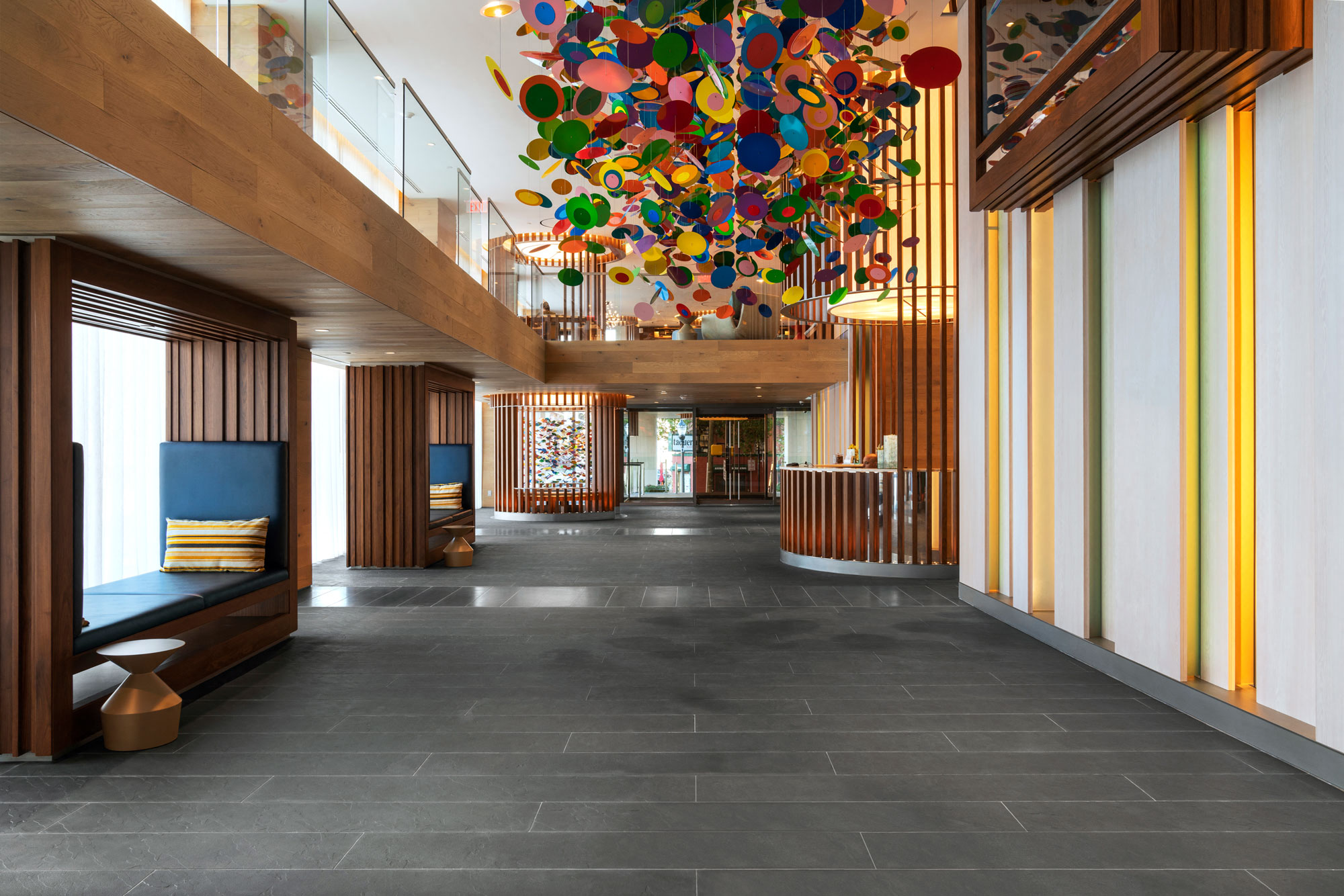 the lobby of a hotel with a large colorful chandelier