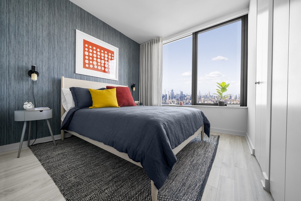 a bedroom with a bed and a large window