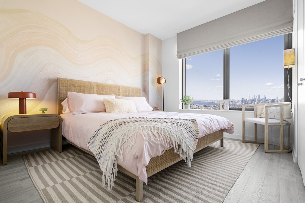 a bedroom with a bed and a large window