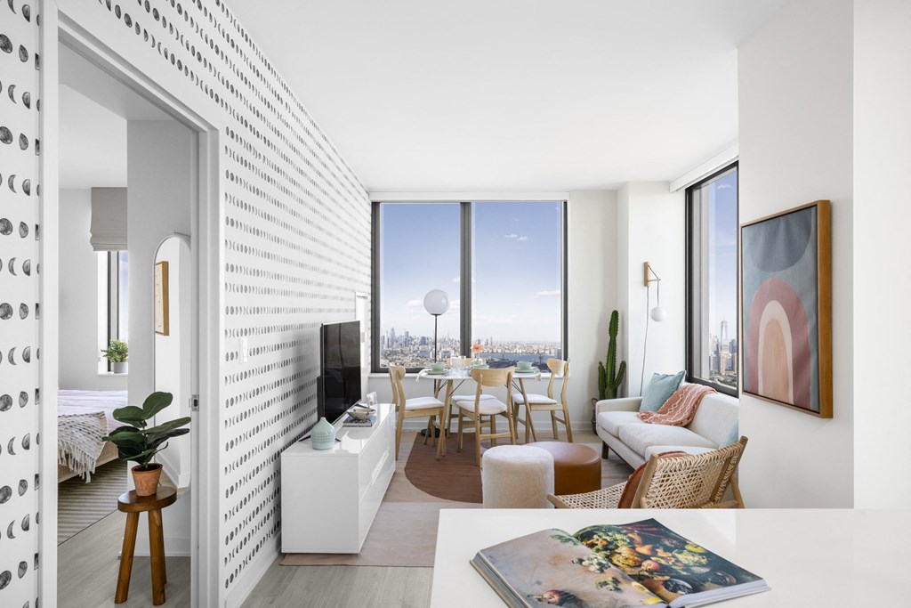 a living room with a couch and a table     and a window