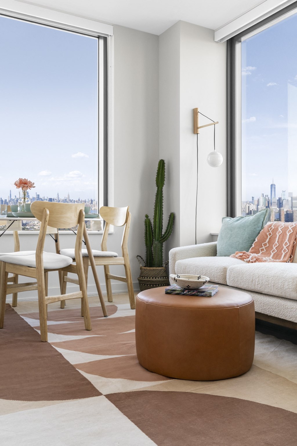 a living room and dining room with a city view and a couch and a table