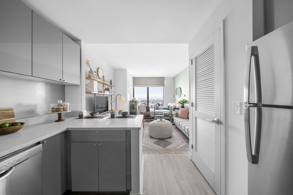 an open kitchen and living room with a view of the living room of a apartment
