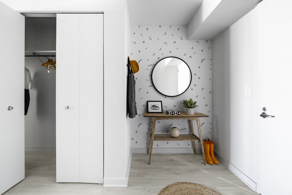 a mirror and a small table in a room with a closet
