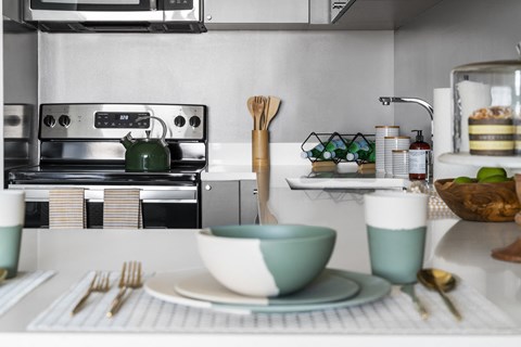 a kitchen with a sink and a table with a bowl and utensils