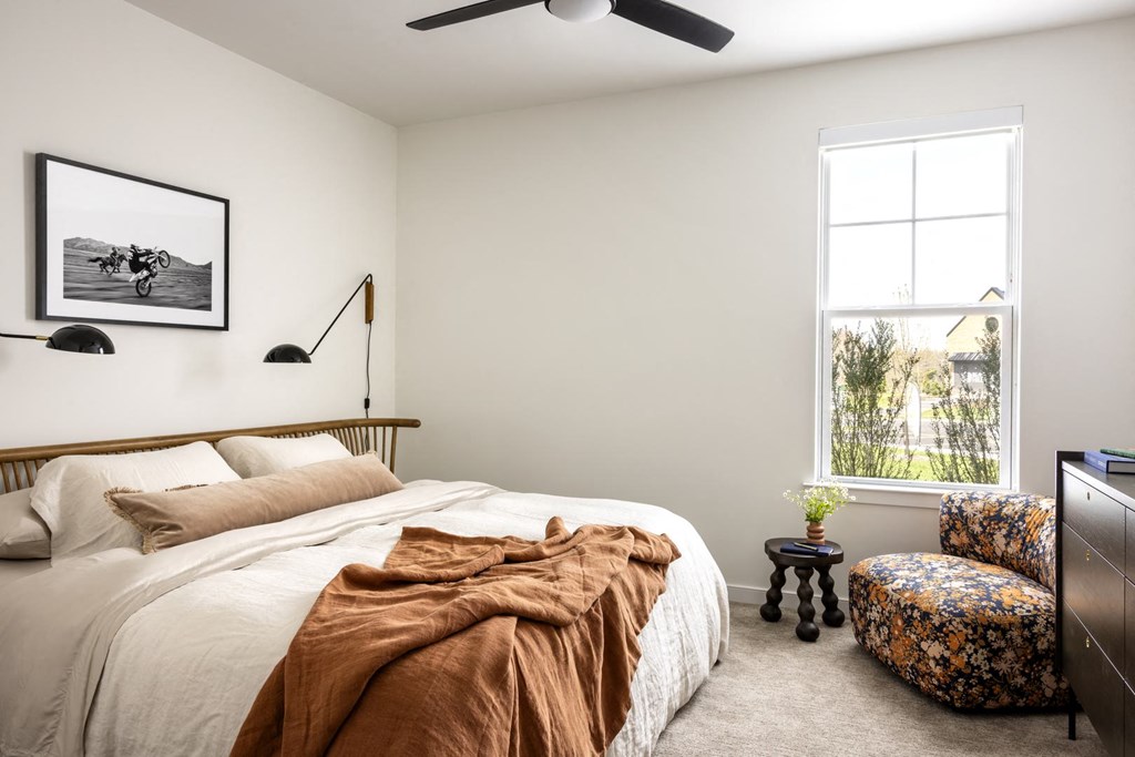 a bedroom with a bed and a window