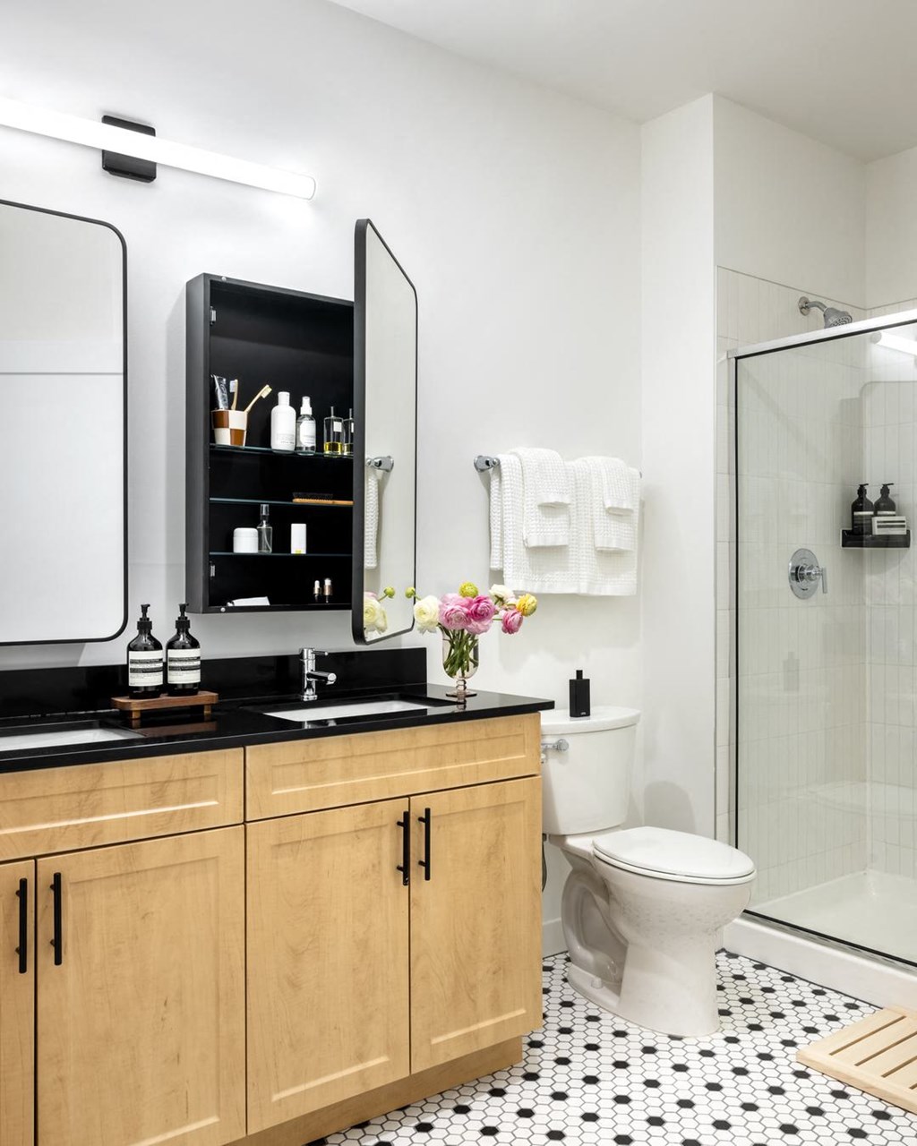 a bathroom with a toilet and a sink and a shower