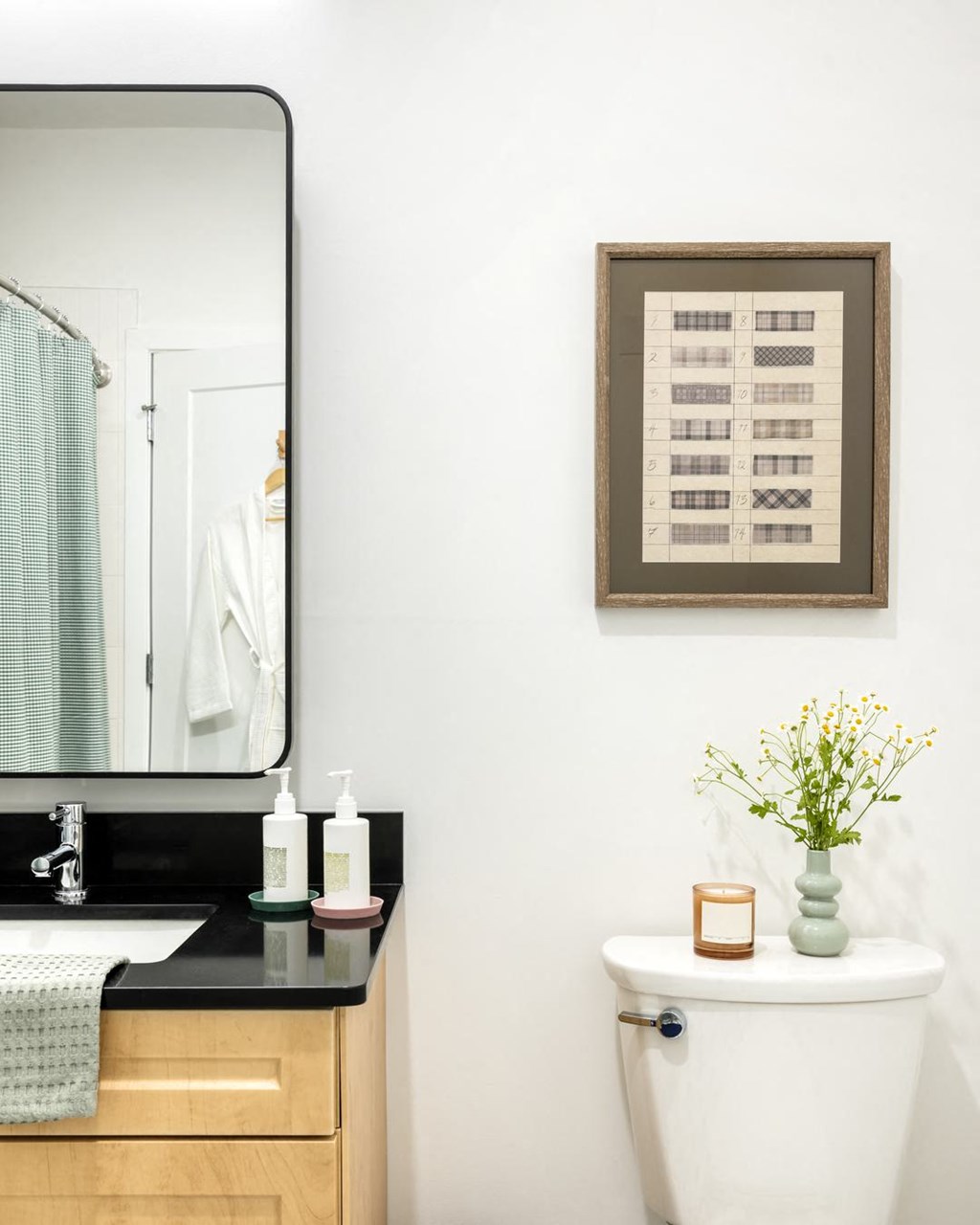 a white bathroom with a toilet and a mirror