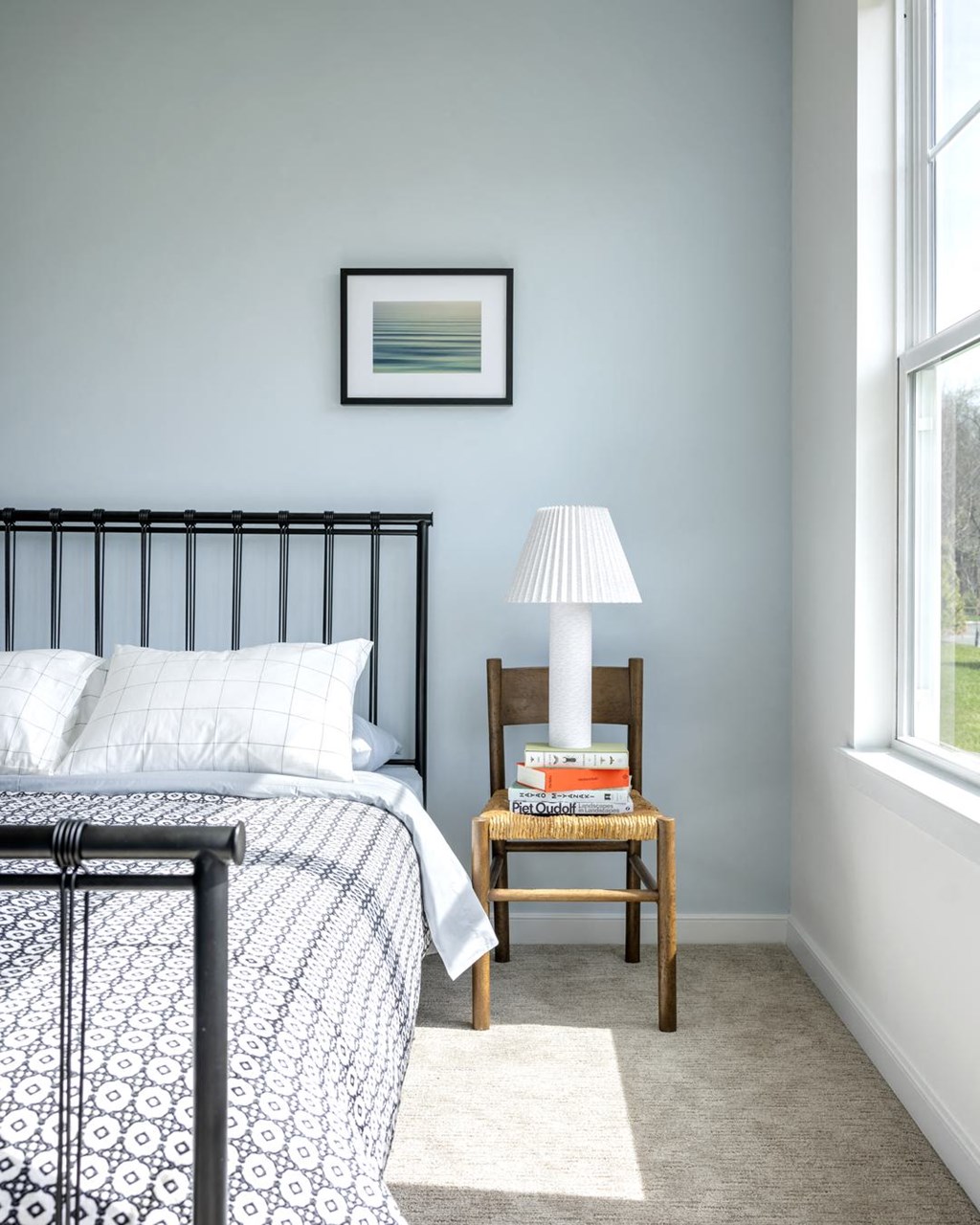 a bedroom with a bed and a table with a lamp