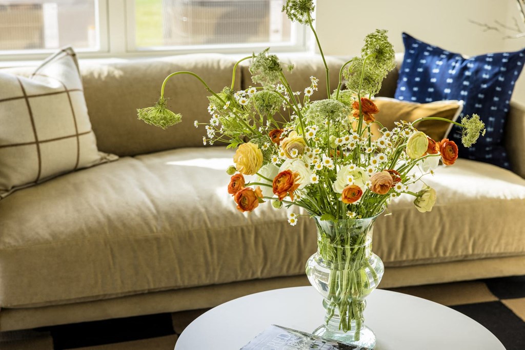 a vase of flowers on a table in a living room