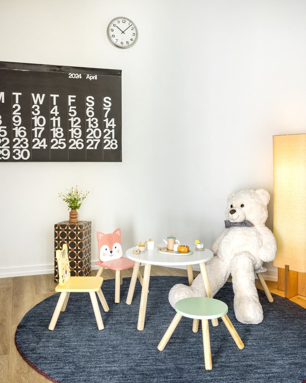 a teddy bear sitting at a table in a room